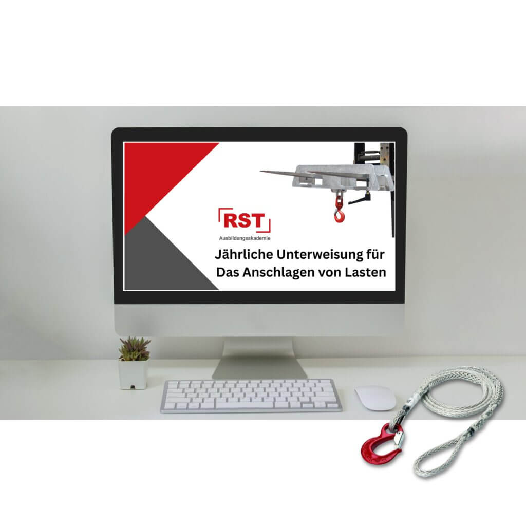 Computer monitor displaying a German safety poster about annual instruction for securing loads, with red and gray geometric design and a hoist image in the corner.