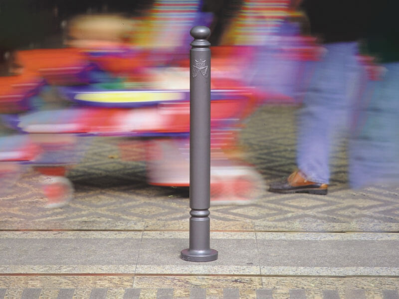 Gelb-schwarze Unterfahrschutz-Balken im Lager, montiert vor Metallregalen mit gestapelten Lagerbehältern.