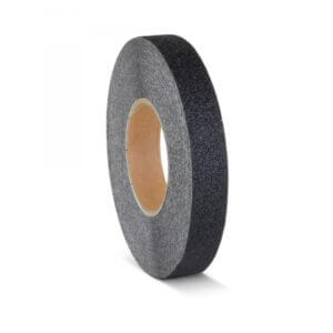 Roll of black textured tape with a brown cardboard core, standing upright on white background.